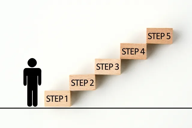 人のアイコンとステップになっているブロック