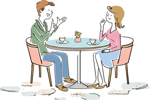 テーブルに座り男女が楽しそうに会話している